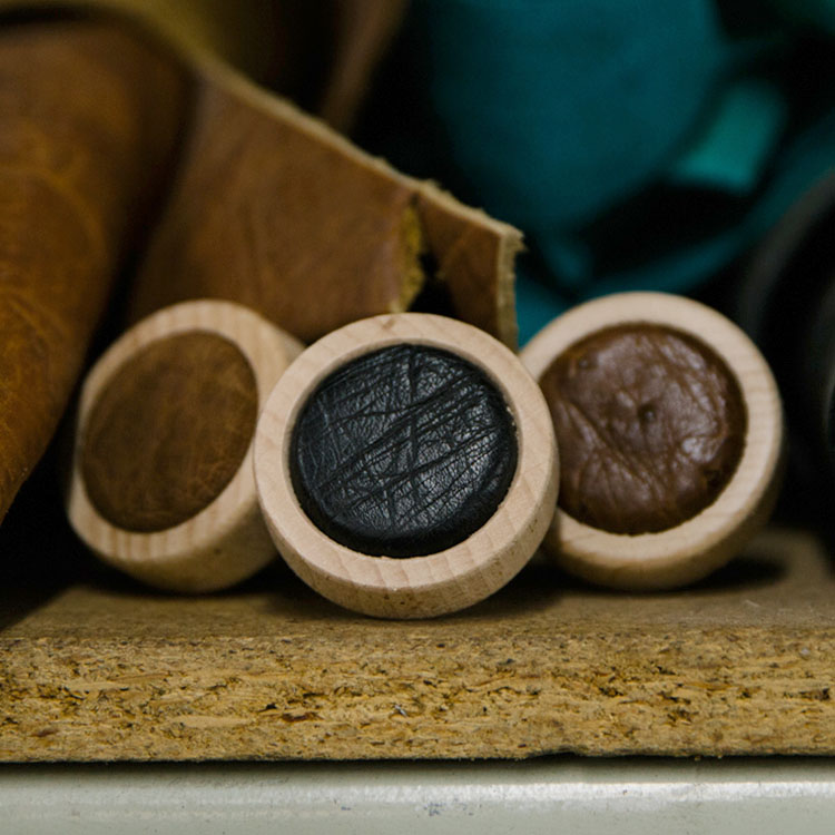 Three leather bottle caps.